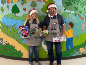 Volunteers with Santa hats and toys