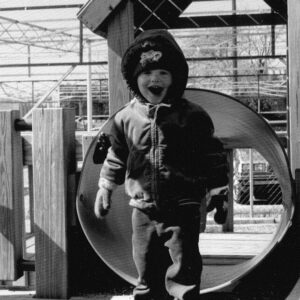 black and white photo of male white child on playground almost 35 years ago